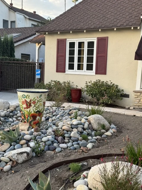 Front garden and river stones during construction, before installation of the Talavera vessel.