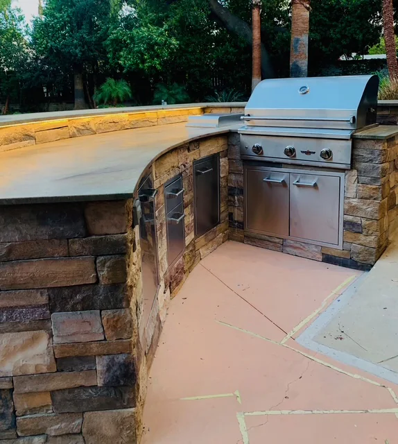 Outdoor BBQ island countertop and built-in grill during installation.