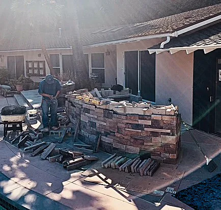 Masonry block base of a custom outdoor BBQ island during construction.