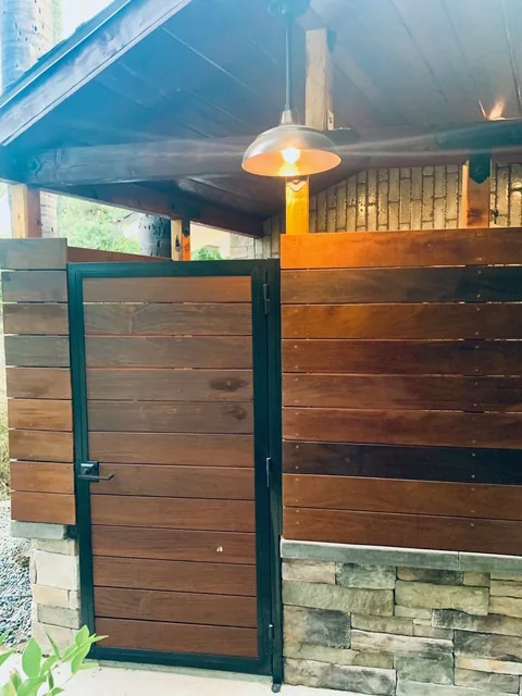 Tropical hardwood boards installed on the poolside outdoor-shower gate.